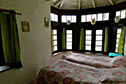 Bedrooms retain the mud walls, high ceilings and wooden roofs